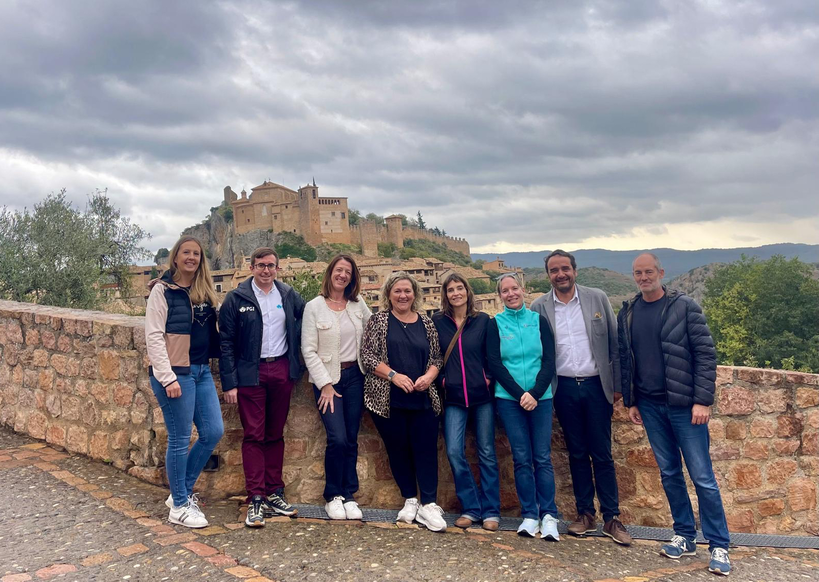 Las delegaciones de Alquézar y Ordino posan con la colegiata al fondo. 